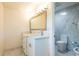 Bathroom featuring marble-look tile, double sinks, and modern fixtures at 3302 W Caracas St, Tampa, FL 33614