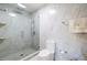 Bathroom featuring marble tile, a glass shower, and modern fixtures at 3302 W Caracas St, Tampa, FL 33614