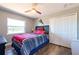 Bedroom with wood-look flooring, ceiling fan, natural light, and closet at 3302 W Caracas St, Tampa, FL 33614