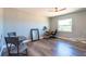 Bedroom with wood-look flooring, a ceiling fan, natural light, and simple furnishings at 3302 W Caracas St, Tampa, FL 33614