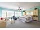 Spacious bedroom with large windows providing natural light and a ceiling fan at 3302 W Caracas St, Tampa, FL 33614