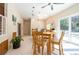 Dining area with a pool view through sliding doors, wood table, and modern light fixture at 3302 W Caracas St, Tampa, FL 33614