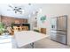 Dining area features tiled floors, a brick accent wall and stainless steel refrigerator at 3302 W Caracas St, Tampa, FL 33614