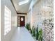 Bright entryway with skylight, decorative screen, and colorful glass details on door at 3302 W Caracas St, Tampa, FL 33614