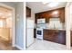 Updated kitchen with dark cabinets, white appliances, and tile flooring at 3302 W Caracas St, Tampa, FL 33614