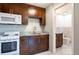 Cozy kitchen features granite countertops, white subway tile backsplash, and wood cabinets with white appliances at 3302 W Caracas St, Tampa, FL 33614