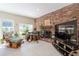 Cozy living room features a brick accent wall, fireplace, and ample natural light at 3302 W Caracas St, Tampa, FL 33614