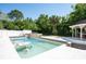 Backyard featuring a pool, gazebo, and mature trees at 3302 W Caracas St, Tampa, FL 33614