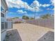 The backyard features a stone ground covering and a partially fenced in yard at 3309 Rock Royal Dr, Holiday, FL 34691