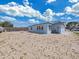 The backyard features a stone ground covering and a partially fenced in yard at 3309 Rock Royal Dr, Holiday, FL 34691