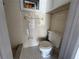 A bathroom featuring white tile, a toilet, and a small window at 3309 Rock Royal Dr, Holiday, FL 34691