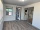 Open dining area showcases the kitchen through sliding doors, featuring wood-look floors at 3309 Rock Royal Dr, Holiday, FL 34691