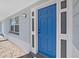 Close up of modern front door and mosaic tile patio with covered porch at 3309 Rock Royal Dr, Holiday, FL 34691