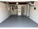 Spacious garage features a full bathroom, utility sink, and newly painted concrete flooring at 3309 Rock Royal Dr, Holiday, FL 34691