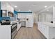 Modern kitchen with stainless steel appliances, white cabinetry, and stylish backsplash at 3309 Rock Royal Dr, Holiday, FL 34691