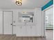 Bright kitchen featuring white cabinetry with a mirror backsplash at 3309 Rock Royal Dr, Holiday, FL 34691
