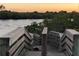 Wood stairs leading to a beautiful water view, surrounded by lush greenery; a serene escape awaits at 3309 Rock Royal Dr, Holiday, FL 34691