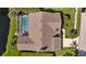 Aerial view of home featuring a screened pool, well-maintained roof, and neat landscaping in a community at 3579 Landmark Trl, Palm Harbor, FL 34684