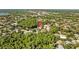 Aerial view of property and surrounding neighborhood; lush trees offer seclusion and privacy at 3579 Landmark Trl, Palm Harbor, FL 34684