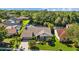 Home with a pond view and landscaping in the front and a screened pool in the back at 3579 Landmark Trl, Palm Harbor, FL 34684