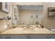 Bathroom vanity featuring a large mirror, granite countertops, and ample storage space at 3579 Landmark Trl, Palm Harbor, FL 34684