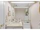 Bright bathroom featuring a granite countertop, framed mirror, and decorative wall accents at 3579 Landmark Trl, Palm Harbor, FL 34684