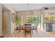 Bright dining room with glass table and backyard views, perfect for entertaining at 3579 Landmark Trl, Palm Harbor, FL 34684