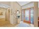 Bright foyer featuring tiled floors, a decorative glass door, and a view into the home at 3579 Landmark Trl, Palm Harbor, FL 34684