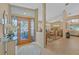 Elegant foyer with decorative glass door, tile flooring, and a glimpse into the dining area at 3579 Landmark Trl, Palm Harbor, FL 34684