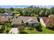 Charming home with a brick driveway, attached garage, and verdant, meticulously maintained landscaping at 3579 Landmark Trl, Palm Harbor, FL 34684