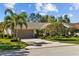 Well maintained home exterior with two palm trees and nicely landscaped yard at 3579 Landmark Trl, Palm Harbor, FL 34684