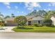 Charming single-story home with well-manicured lawn, mature landscaping, and a two-car garage at 3579 Landmark Trl, Palm Harbor, FL 34684