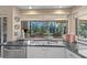 Bright kitchen sink with a view of the backyard pool and landscaping at 3579 Landmark Trl, Palm Harbor, FL 34684