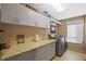 Large laundry room with granite countertops, ample cabinet space, and modern washer and dryer at 3579 Landmark Trl, Palm Harbor, FL 34684
