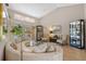 Bright living room featuring vaulted ceilings, sliding glass doors, and elegant decor at 3579 Landmark Trl, Palm Harbor, FL 34684