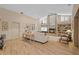Bright living room featuring hardwood floors, fireplace, built-in bookshelves, and high ceilings at 3579 Landmark Trl, Palm Harbor, FL 34684
