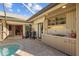 Outdoor kitchen featuring built-in appliances and bar top seating on a screened lanai at 3579 Landmark Trl, Palm Harbor, FL 34684