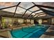 A screened in in-ground pool and outside seating at 3579 Landmark Trl, Palm Harbor, FL 34684