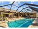 Enjoy this spacious pool area with ample seating and shade for outdoor entertaining at 3579 Landmark Trl, Palm Harbor, FL 34684