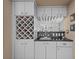 The wet bar boasts stylish cabinets, a wine rack, and glass storage for all your entertaining needs at 3579 Landmark Trl, Palm Harbor, FL 34684
