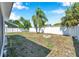 Spacious backyard with a privacy fence, shade trees and a charming brick fire pit for outdoor enjoyment at 3624 Hendrix St, New Port Richey, FL 34652
