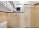 Compact bathroom featuring a tiled wall, mirror, and towel racks presenting a functional and convenient space at 3624 Hendrix St, New Port Richey, FL 34652