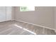 This bedroom features durable flooring, a window, and a closet at 3624 Hendrix St, New Port Richey, FL 34652