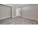 Bedroom featuring durable flooring with a closet and entry door at 3624 Hendrix St, New Port Richey, FL 34652