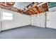 Spacious two car garage with concrete block walls, painted floor, and overhead door with windows at 3624 Hendrix St, New Port Richey, FL 34652