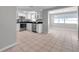 Bright kitchen featuring white cabinets, stainless steel appliances, and black countertops at 3624 Hendrix St, New Port Richey, FL 34652