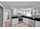 Bright kitchen with white cabinets, stainless steel appliances, and open shelving at 3624 Hendrix St, New Port Richey, FL 34652