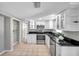 Well-lit kitchen with white cabinets, stainless steel appliances, and convenient storage at 3624 Hendrix St, New Port Richey, FL 34652