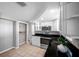 Functional kitchen featuring white cabinets, stainless steel appliances, and open shelving at 3624 Hendrix St, New Port Richey, FL 34652