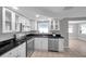 Modern kitchen with white cabinets, stainless steel appliances, and elegant black countertops at 3624 Hendrix St, New Port Richey, FL 34652
